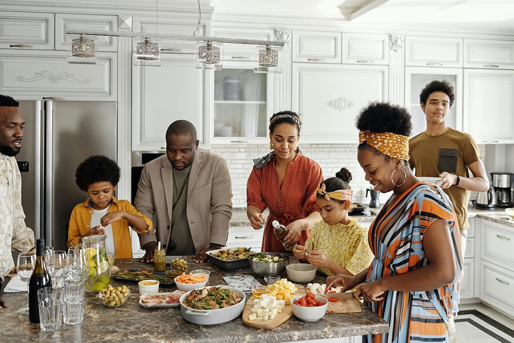 Family standing around the kitchen